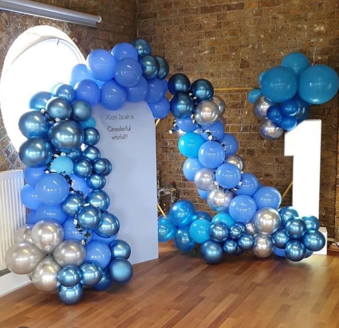 Blue and silver balloon arch with number 1 for a first birthday