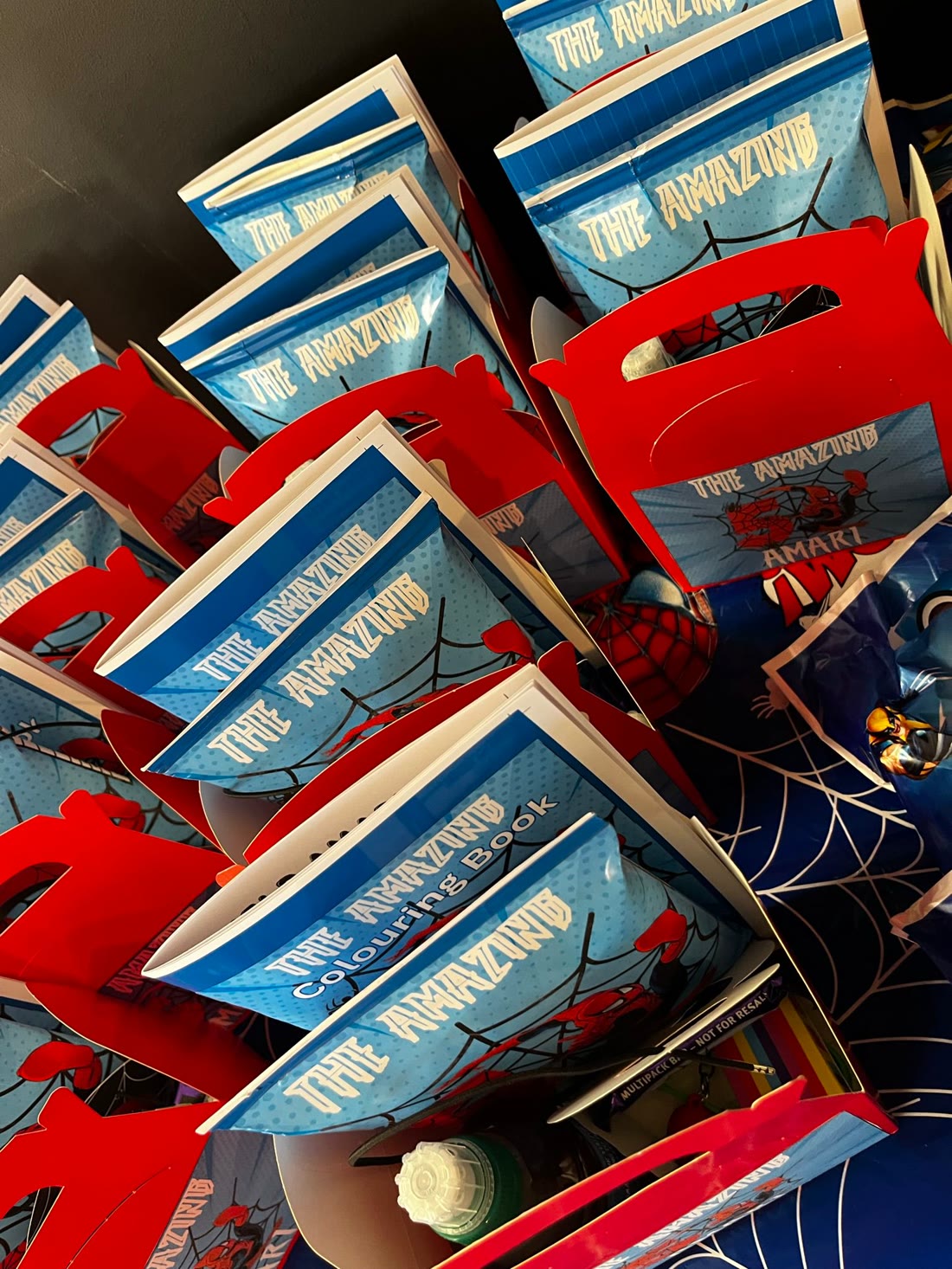Themed favour packs in red gable boxes with colouring books