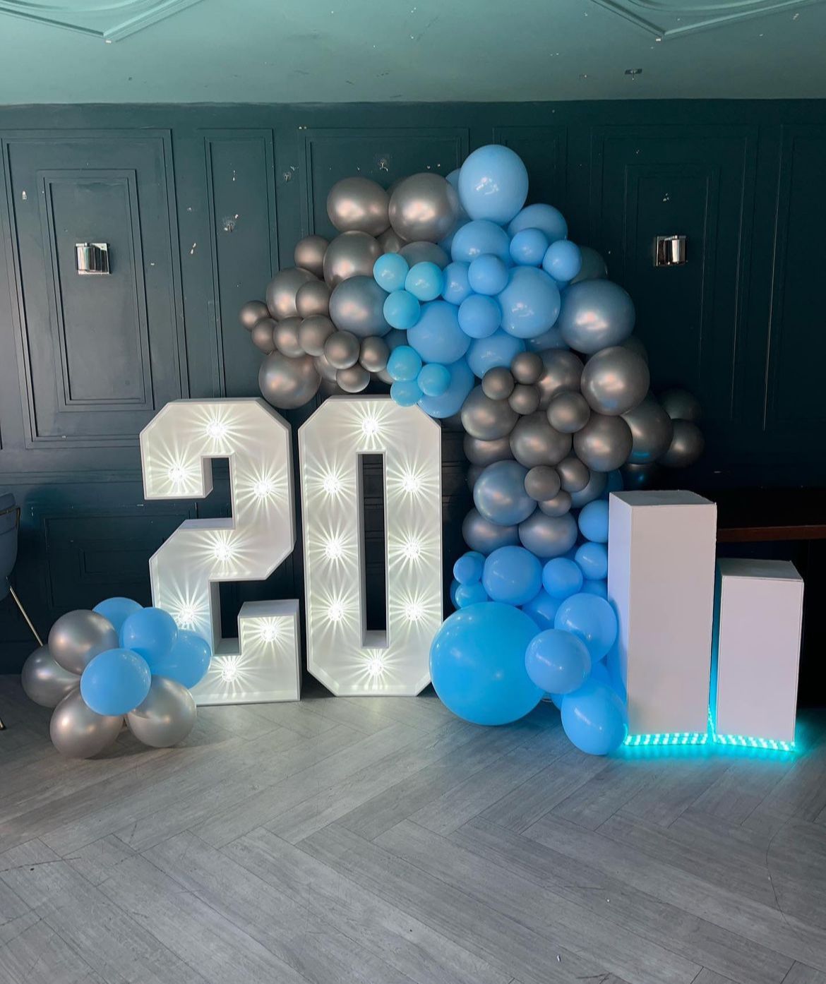 Blue and silver balloon wall with light-up number 30
