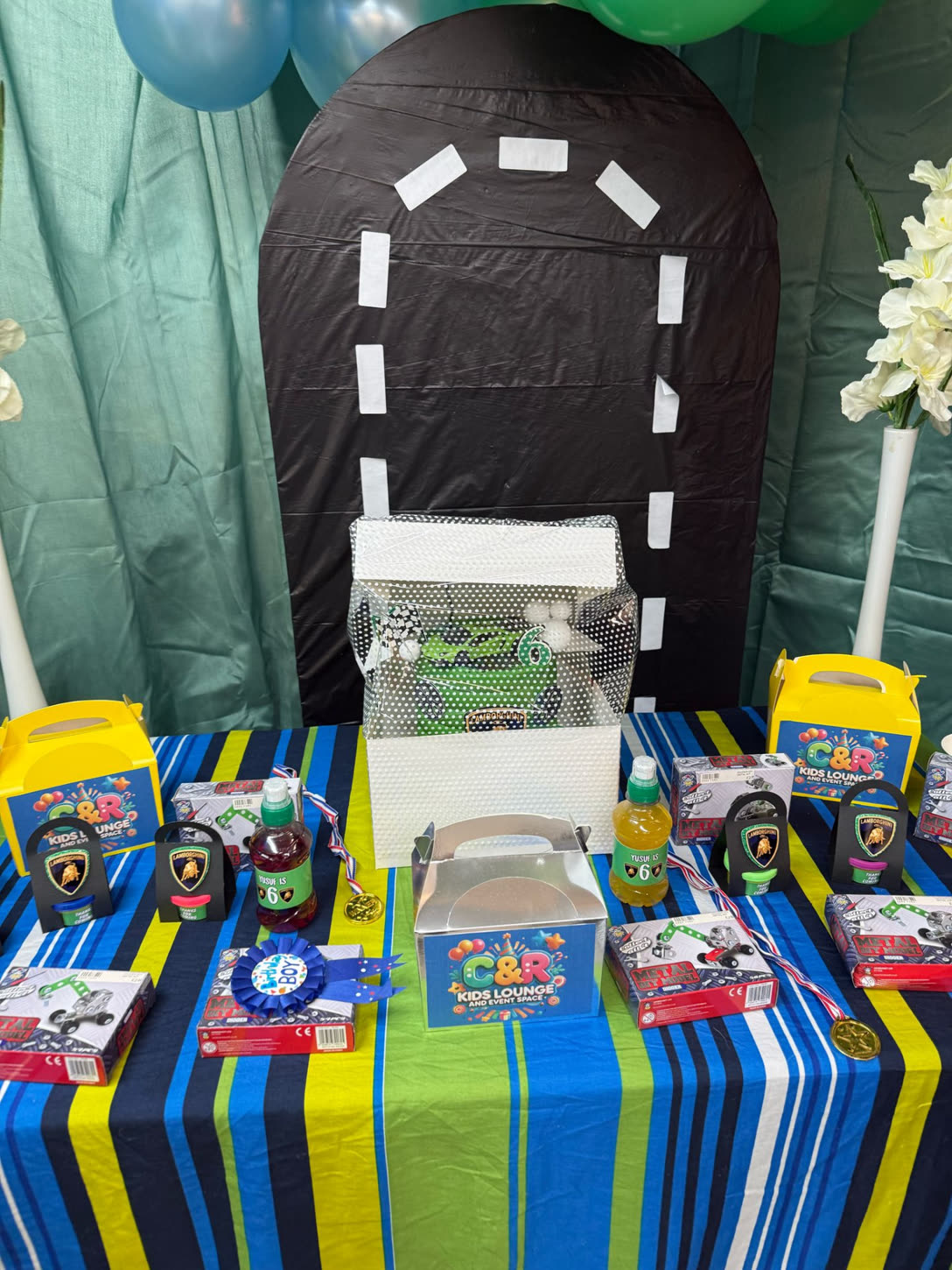Dessert & favours table with road-themed backdrop