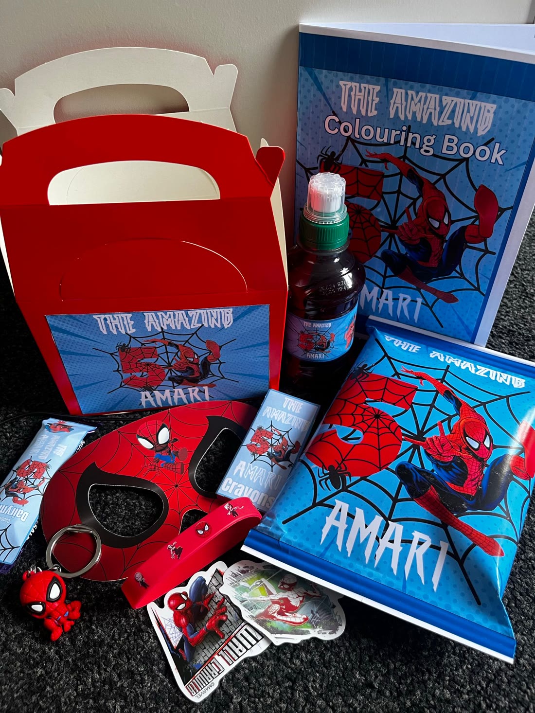 Full favour set laid out — bottle, books, mask, crayons & treats