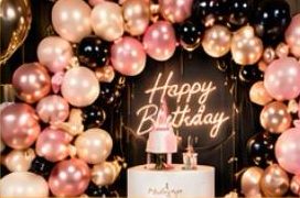 Pink balloon garland with Happy Birthday neon